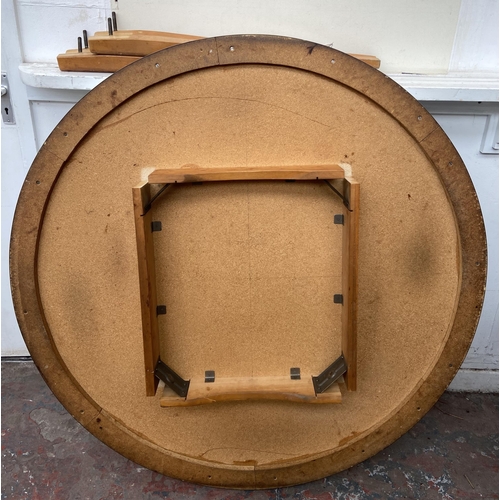 102 - A mid 20th century white laminate circular dining table on beech supports - approx. 123cm diameter