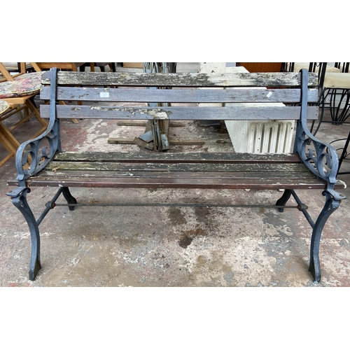 106 - A Victorian style cast metal and wooden slatted garden bench - approx. 72cm high x 124cm wide x 50cm... 