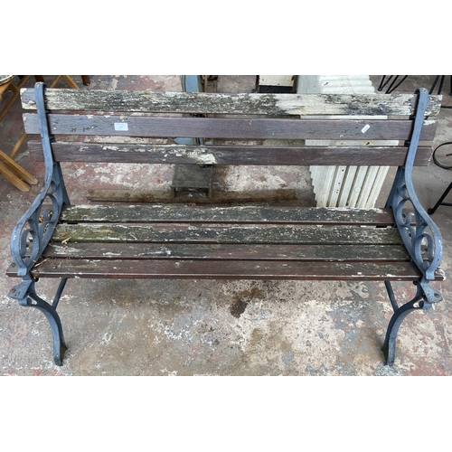 106 - A Victorian style cast metal and wooden slatted garden bench - approx. 72cm high x 124cm wide x 50cm... 