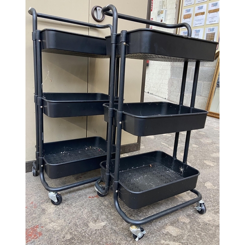 112 - A pair of black metal and plastic three tier storage trolleys - approx. 86cm high x 40cm wide x 30cm... 