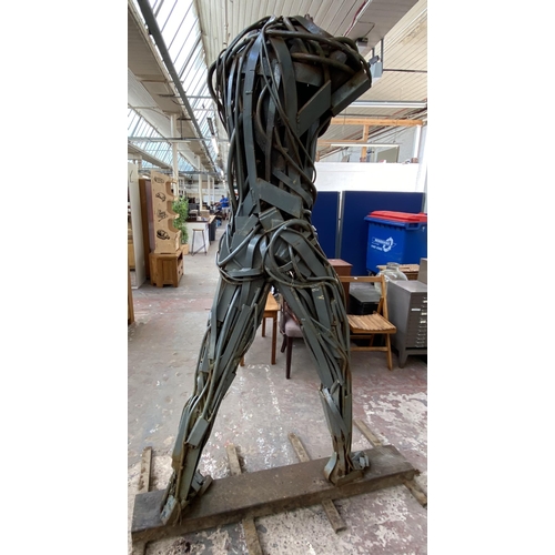 112A - A Neil Wood metal nude male sculpture - approx. 210cm high x 144cm wide x 95cm deep