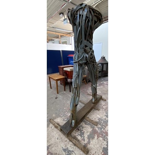 112A - A Neil Wood metal nude male sculpture - approx. 210cm high x 144cm wide x 95cm deep