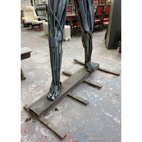 112A - A Neil Wood metal nude male sculpture - approx. 210cm high x 144cm wide x 95cm deep