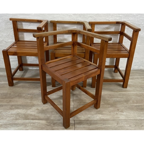 125 - Four teak outdoor corner chairs - approx. 74cm high