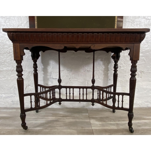 131 - A 19th century inlaid rosewood fold over games table with reeded supports and galleried stretcher - ... 