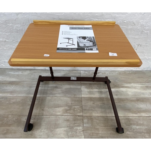 136 - An Able 2 over chair table with instruction manual