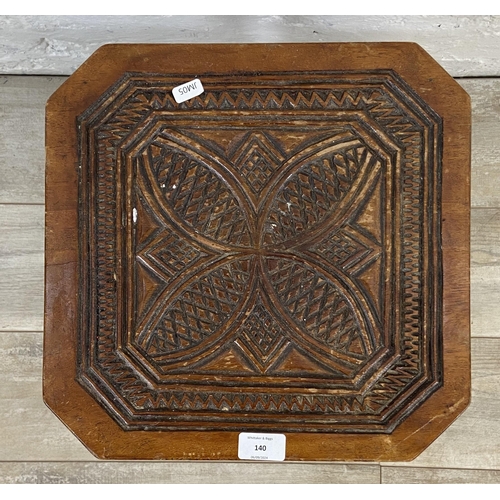 140 - A 1930s carved wood octagonal three tier side table - approx. 48cm high x 35cm wide x 35cm deep