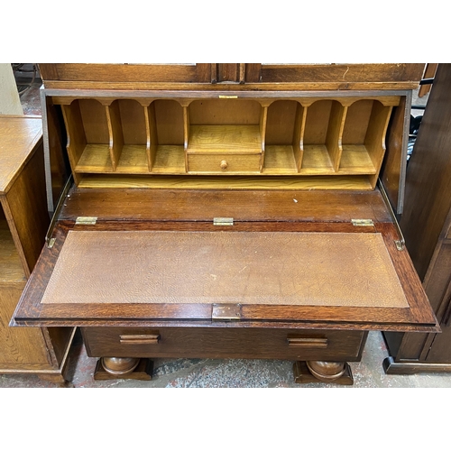 142 - An Art Deco carved oak bureau bookcase on baluster supports - approx. 198cm high x 91cm wide x 42cm ... 