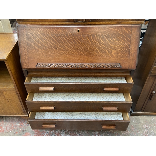 142 - An Art Deco carved oak bureau bookcase on baluster supports - approx. 198cm high x 91cm wide x 42cm ... 