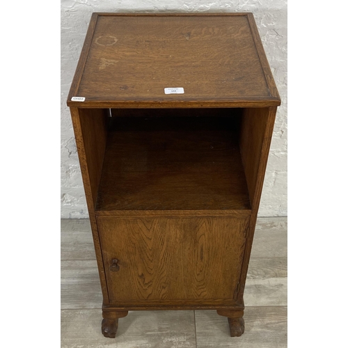 143 - A mid 20th century oak bedside cabinet - approx. 86cm high x 41cm wide x 41cm deep