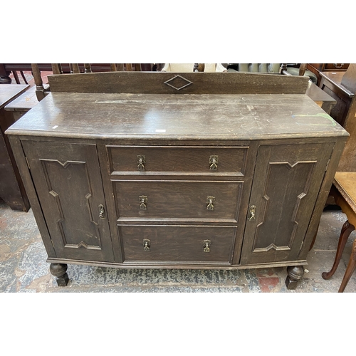 152 - An early 20th century carved oak sideboard - approx. 104cm high x 130cm wide x 48cm deep