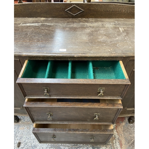 152 - An early 20th century carved oak sideboard - approx. 104cm high x 130cm wide x 48cm deep