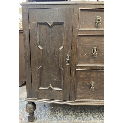 152 - An early 20th century carved oak sideboard - approx. 104cm high x 130cm wide x 48cm deep