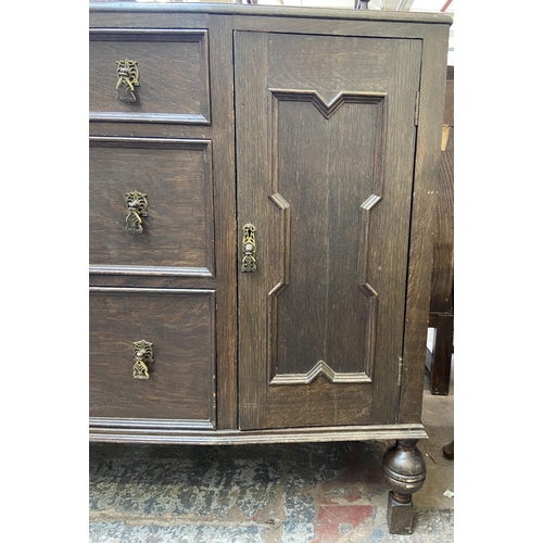 152 - An early 20th century carved oak sideboard - approx. 104cm high x 130cm wide x 48cm deep