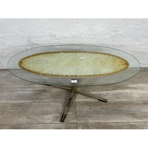 157 - A mid 20th century glass top oval coffee table - approx. 39cm high x 43cm wide x 98cm long