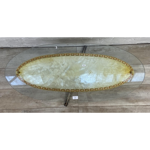 157 - A mid 20th century glass top oval coffee table - approx. 39cm high x 43cm wide x 98cm long