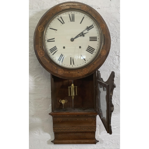 26 - A late 19th/early 20th century American inlaid walnut cased drop dial wall clock with winder and pen... 