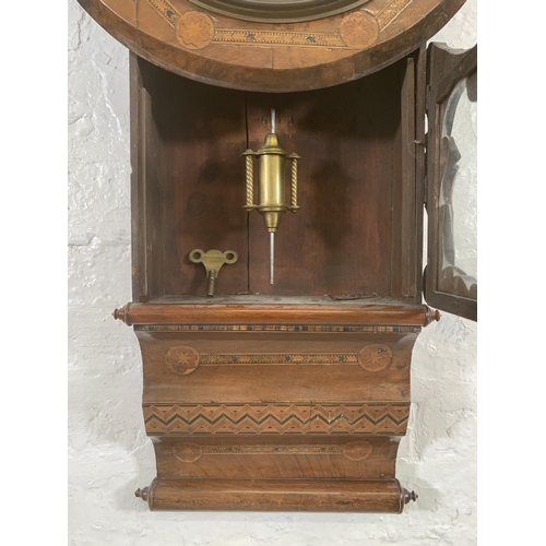 26 - A late 19th/early 20th century American inlaid walnut cased drop dial wall clock with winder and pen... 