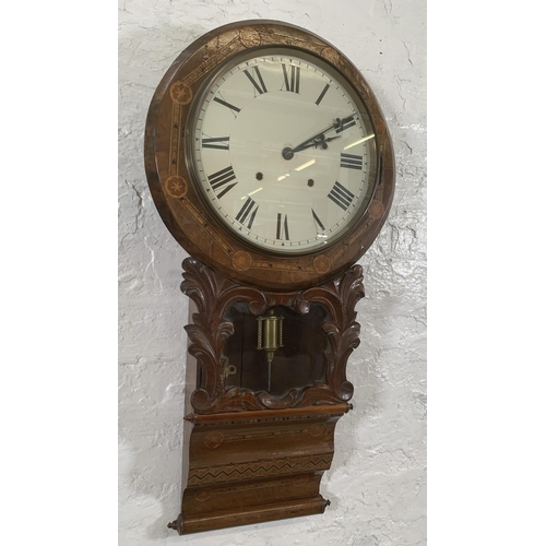 26 - A late 19th/early 20th century American inlaid walnut cased drop dial wall clock with winder and pen... 