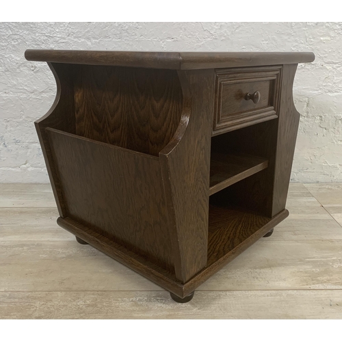 29 - An oak magazine rack side table - approx. 47cm high x 50cm wide x 45cm deep