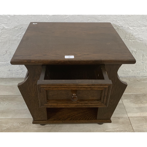 29 - An oak magazine rack side table - approx. 47cm high x 50cm wide x 45cm deep