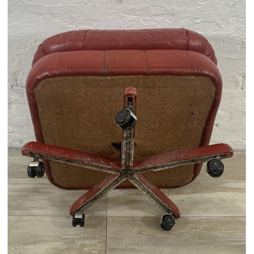 3 - A mid 20th century red leather swivel footstool on castors - approx. 46cm high x 66cm wide