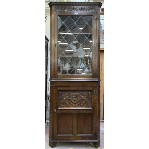 30 - A Jaycee carved oak free standing corner cabinet - approx. 185cm high