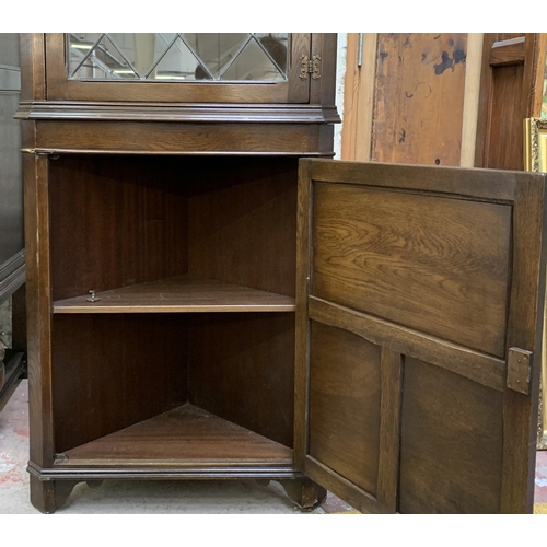 30 - A Jaycee carved oak free standing corner cabinet - approx. 185cm high