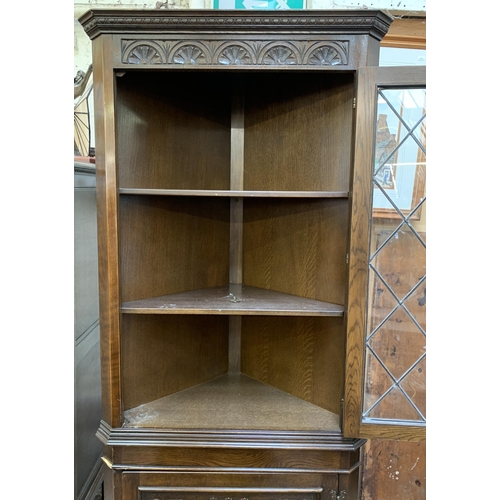 30 - A Jaycee carved oak free standing corner cabinet - approx. 185cm high