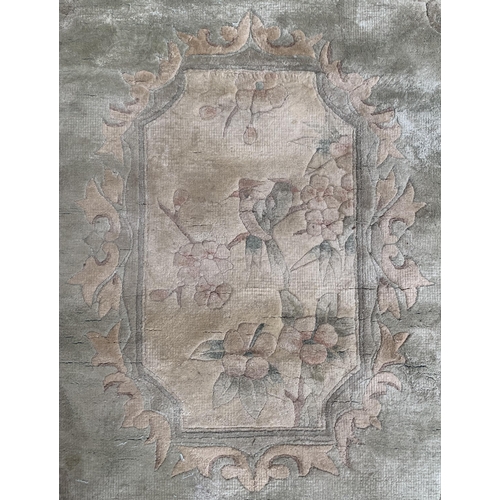 37 - A machine woven green ground floral pattern rug - approx. 190cm x 120xm