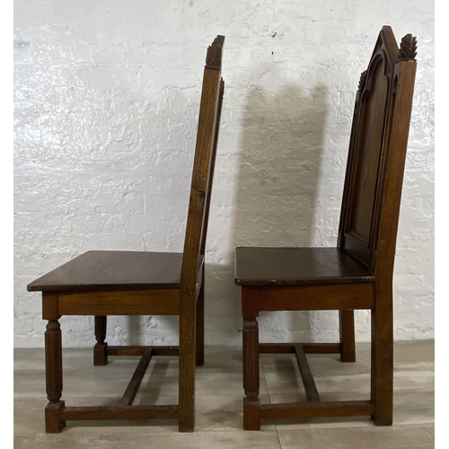 38 - A pair of Gothic style carved oak ecclesiastical type dining/hall chairs with reeded supports and 