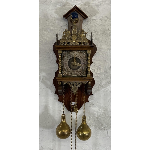 39 - A Dutch Zaanse brass and mahogany double weight wall clock - approx. 51cm high