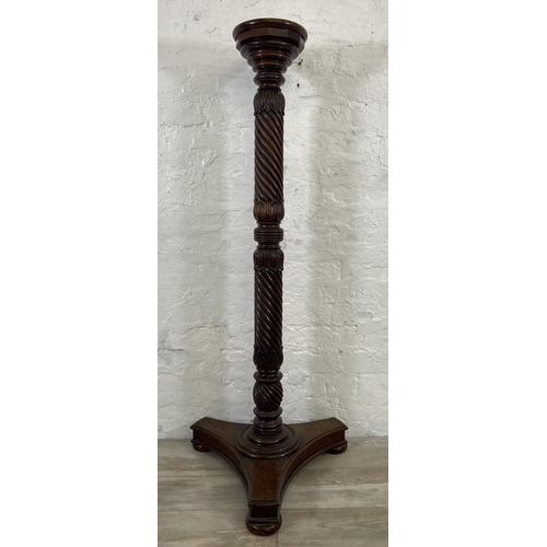 40 - An early/mid 19th century carved mahogany circular top torchere on tripod pedestal support - approx.... 