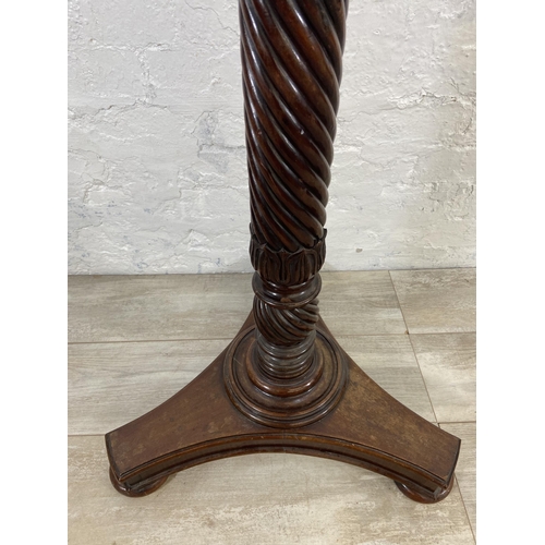 40 - An early/mid 19th century carved mahogany circular top torchere on tripod pedestal support - approx.... 