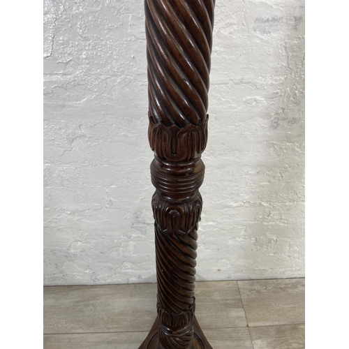 40 - An early/mid 19th century carved mahogany circular top torchere on tripod pedestal support - approx.... 