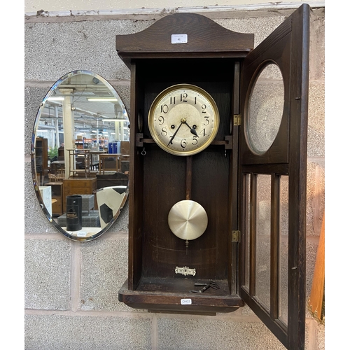 41 - Two items, one early/mid 20th century oak cased chiming wall clock with pendulum and winder - approx... 