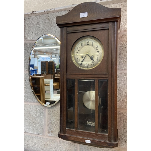 41 - Two items, one early/mid 20th century oak cased chiming wall clock with pendulum and winder - approx... 