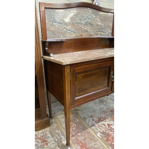 47 - An Edwardian inlaid mahogany and marble wash stand on tapering supports with two cupboard doors and ... 