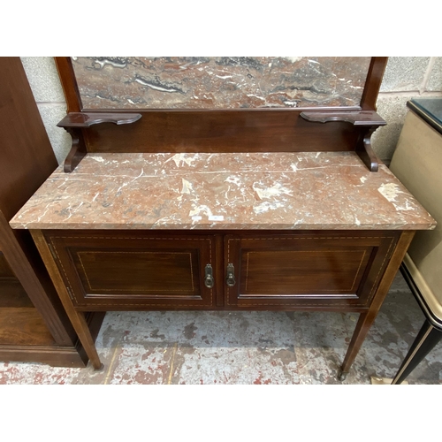 47 - An Edwardian inlaid mahogany and marble wash stand on tapering supports with two cupboard doors and ... 