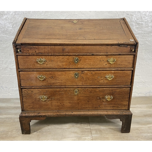 49 - A George III oak bureau on bracket supports - approx. 98cm high x 90cm wide x 55cm deep