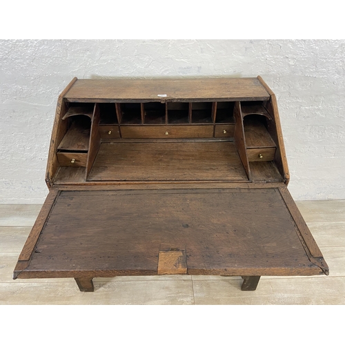 49 - A George III oak bureau on bracket supports - approx. 98cm high x 90cm wide x 55cm deep