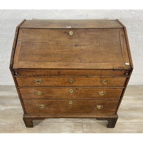 49 - A George III oak bureau on bracket supports - approx. 98cm high x 90cm wide x 55cm deep