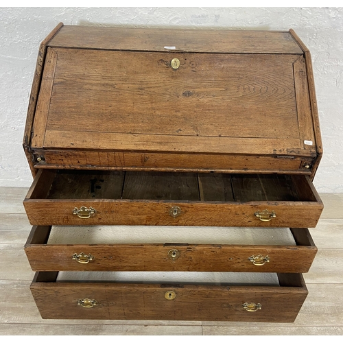 49 - A George III oak bureau on bracket supports - approx. 98cm high x 90cm wide x 55cm deep