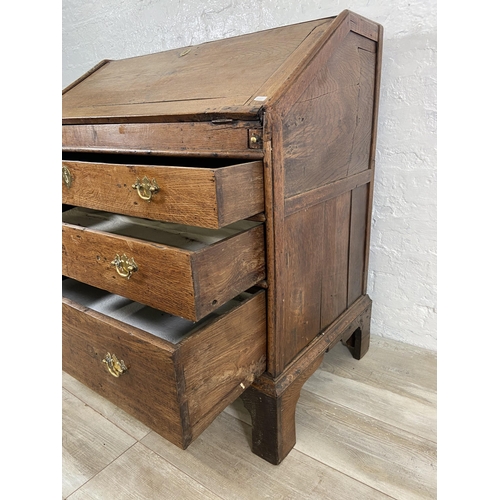 49 - A George III oak bureau on bracket supports - approx. 98cm high x 90cm wide x 55cm deep