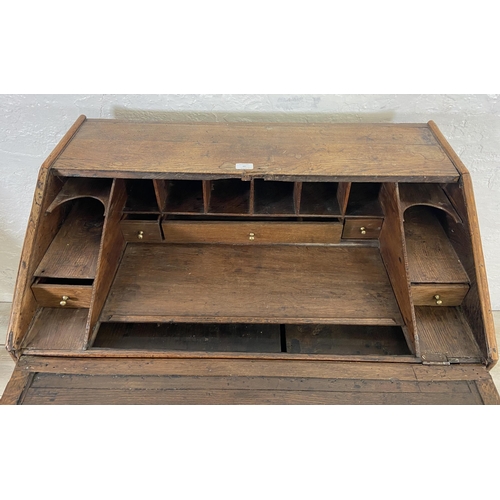 49 - A George III oak bureau on bracket supports - approx. 98cm high x 90cm wide x 55cm deep