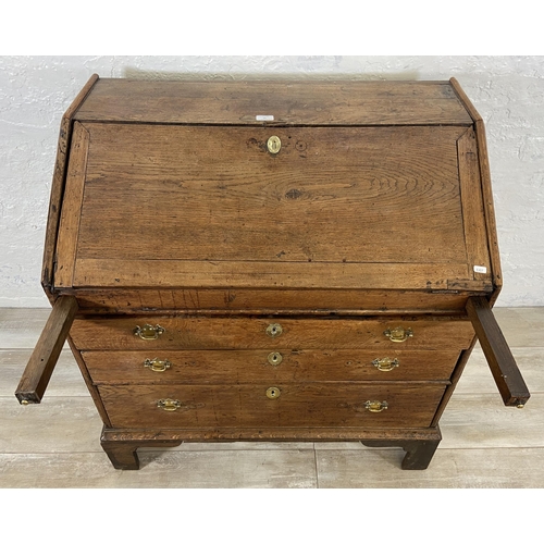 49 - A George III oak bureau on bracket supports - approx. 98cm high x 90cm wide x 55cm deep