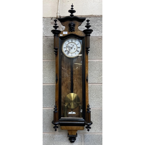 50 - A Victorian walnut and ebonised cased Vienna wall clock with pendulum, weights and winder - approx. ... 