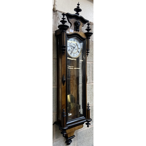 50 - A Victorian walnut and ebonised cased Vienna wall clock with pendulum, weights and winder - approx. ... 