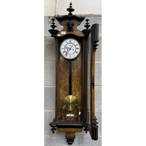 50 - A Victorian walnut and ebonised cased Vienna wall clock with pendulum, weights and winder - approx. ... 