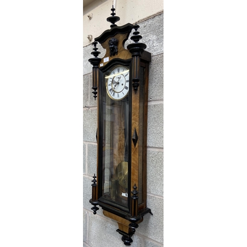 50 - A Victorian walnut and ebonised cased Vienna wall clock with pendulum, weights and winder - approx. ... 